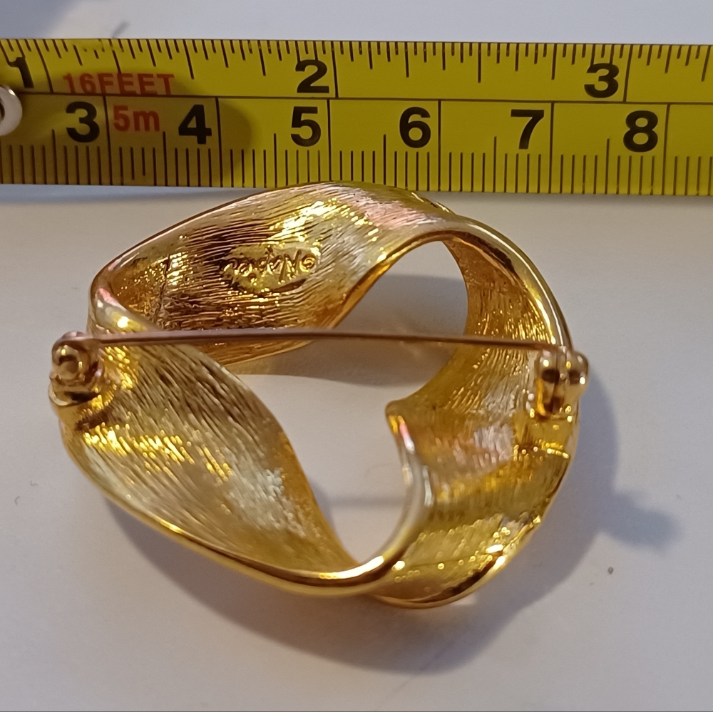 Gold colored broach pin